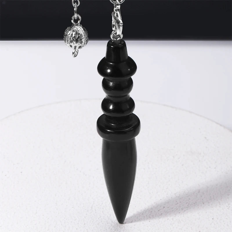 Black pendant necklace on a white background