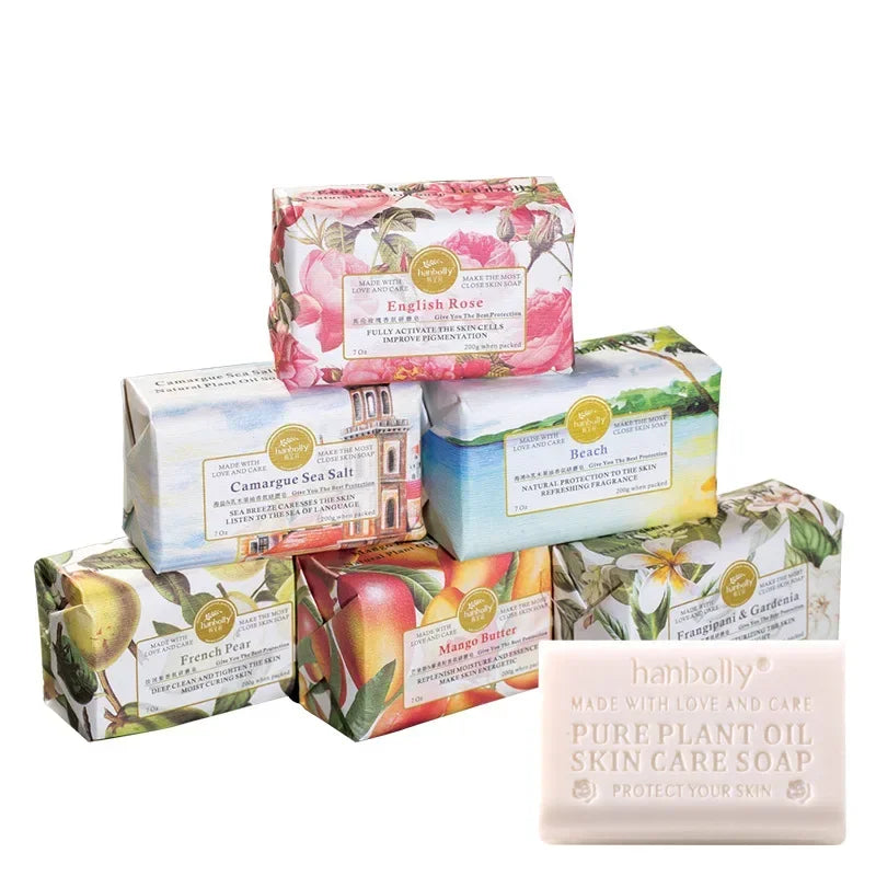 Collection of various soap bars with decorative packaging on a white background