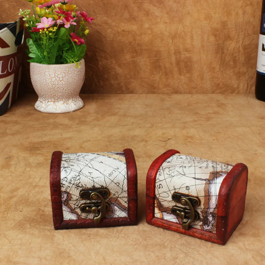 Two small wooden treasure chest boxes with map design on a wooden surface.