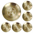 Set of six brass discs with engraved symbols on a white background