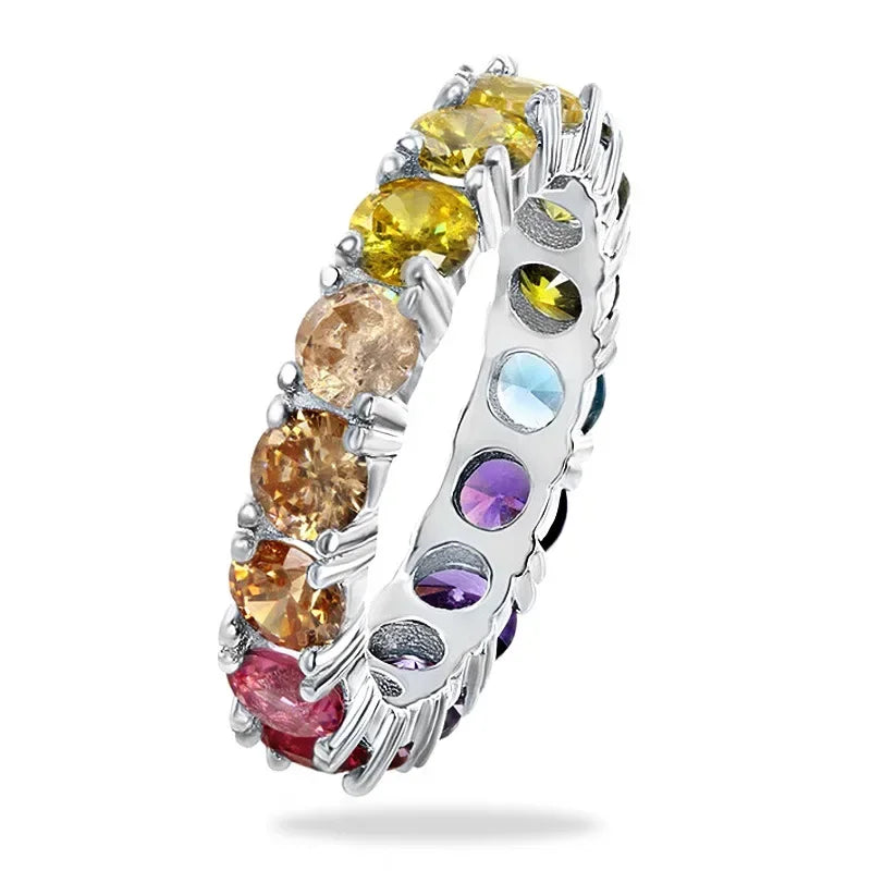 Silver ring with multicolored gemstones on a white background
