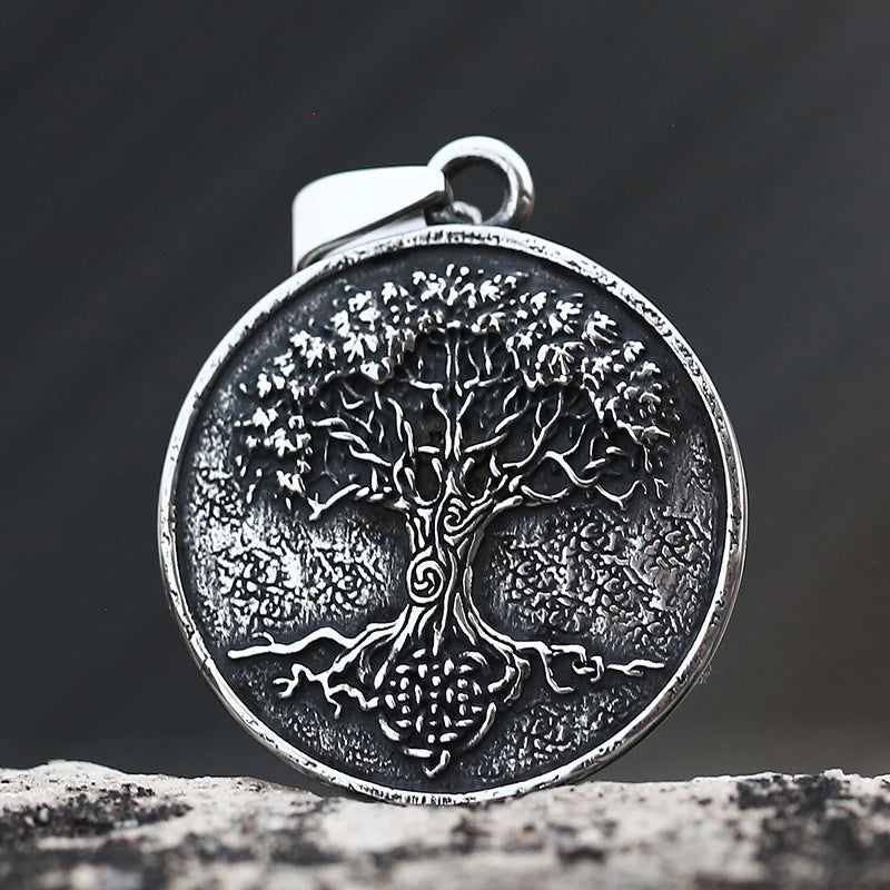 Silver tree pendant on a dark background