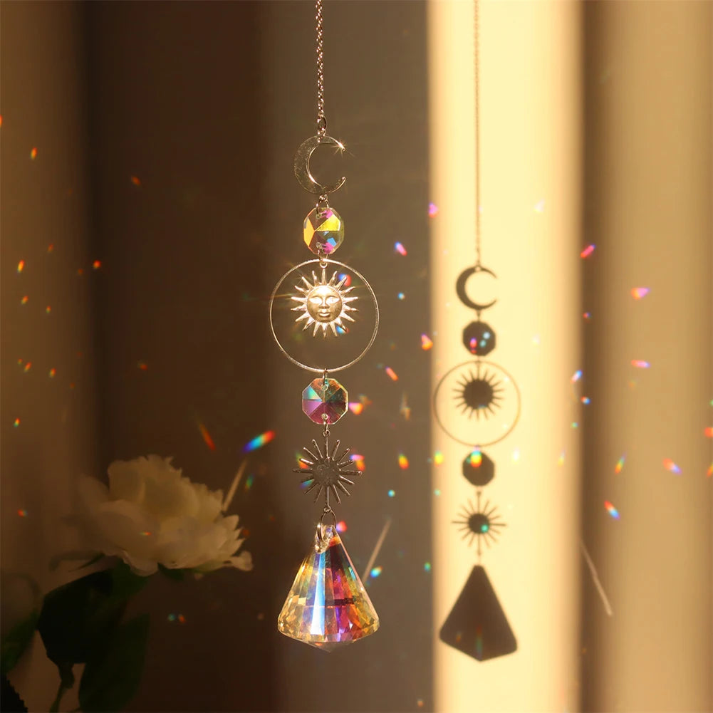 Decorative hanging crystal with sun and moon designs against a warm background