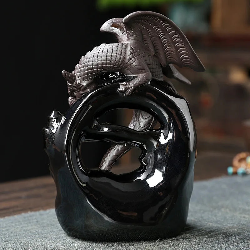 Decorative black vase with eagle design on a textured surface