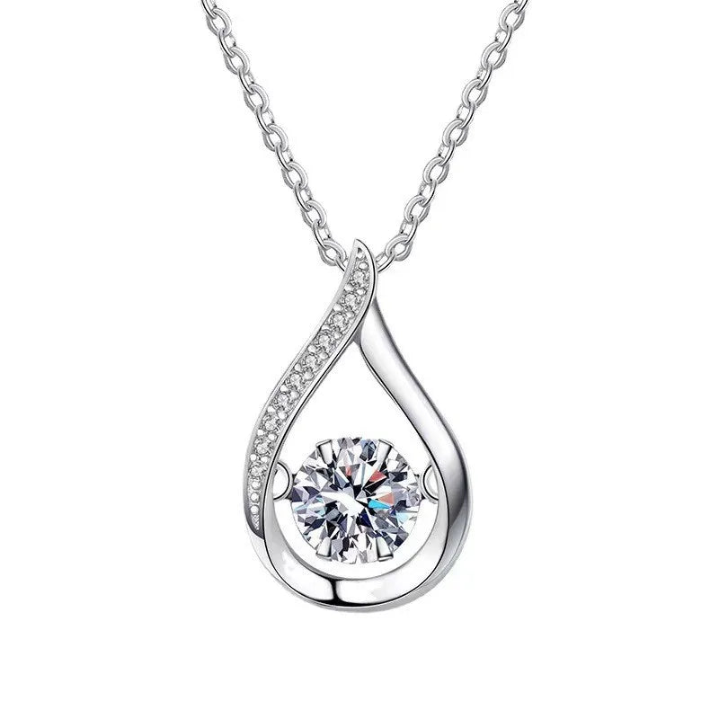 Silver teardrop-shaped pendant with a clear gemstone on a white background