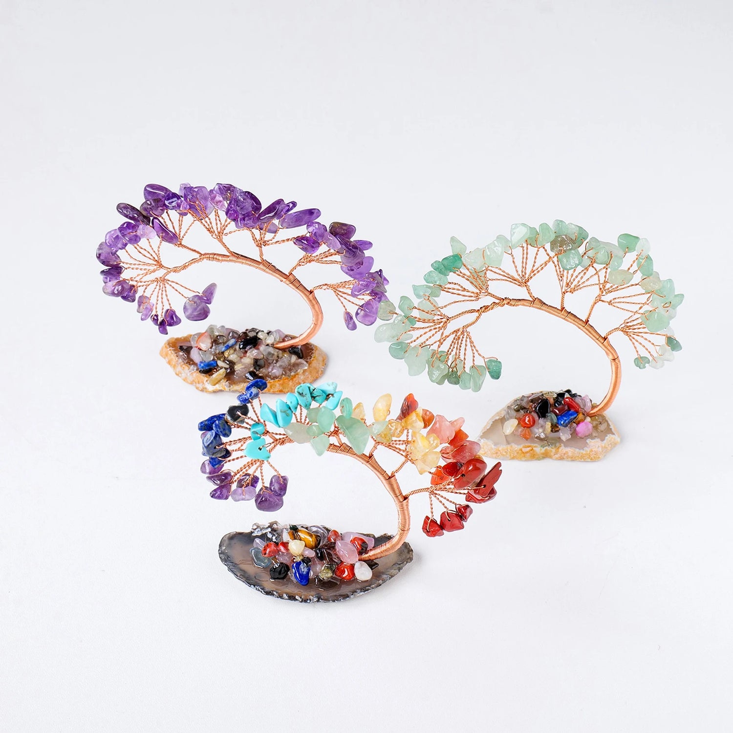 Colorful crystal tree sculptures on a white background