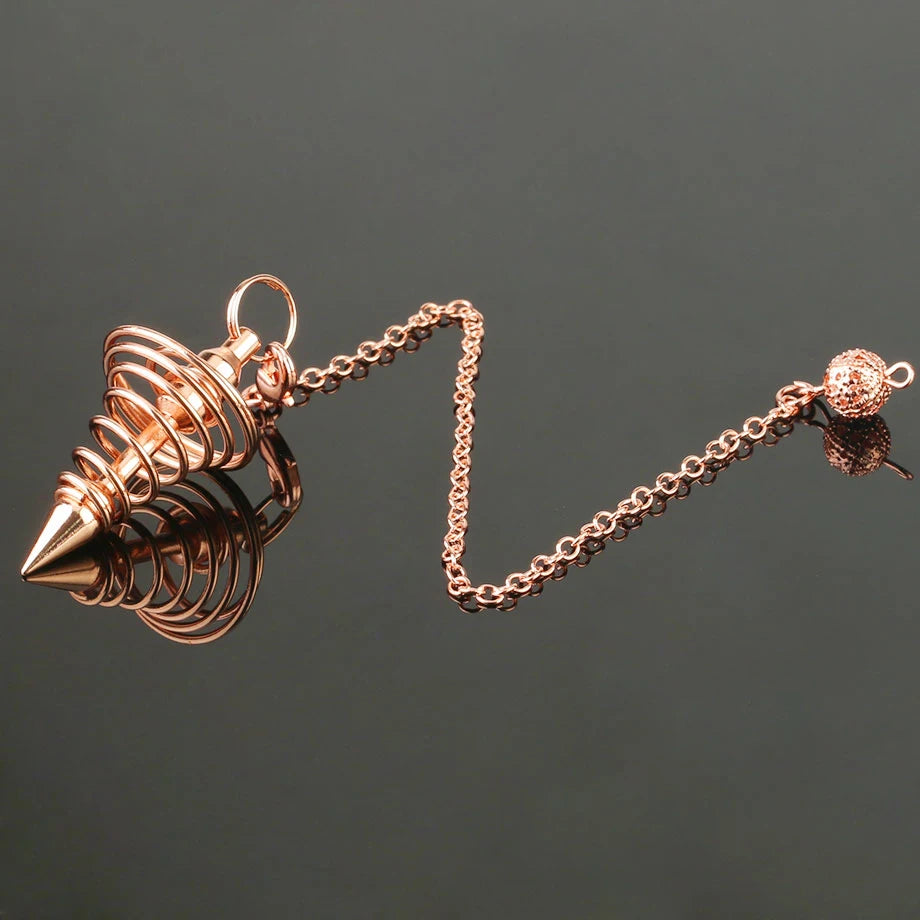 Rose gold spike pendant on a chain against a dark background