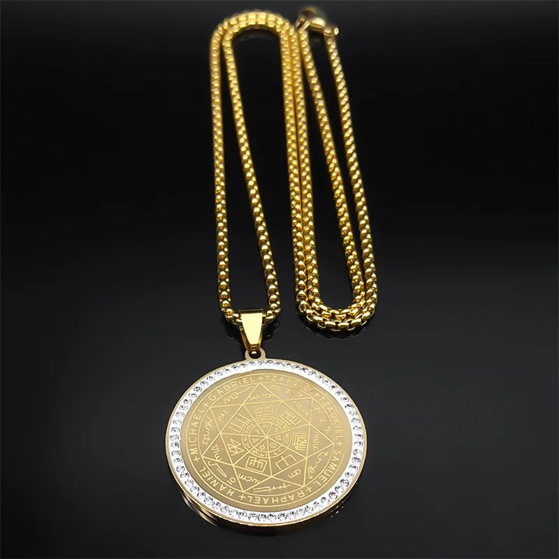 Gold necklace with a pyramid design pendant on a black background