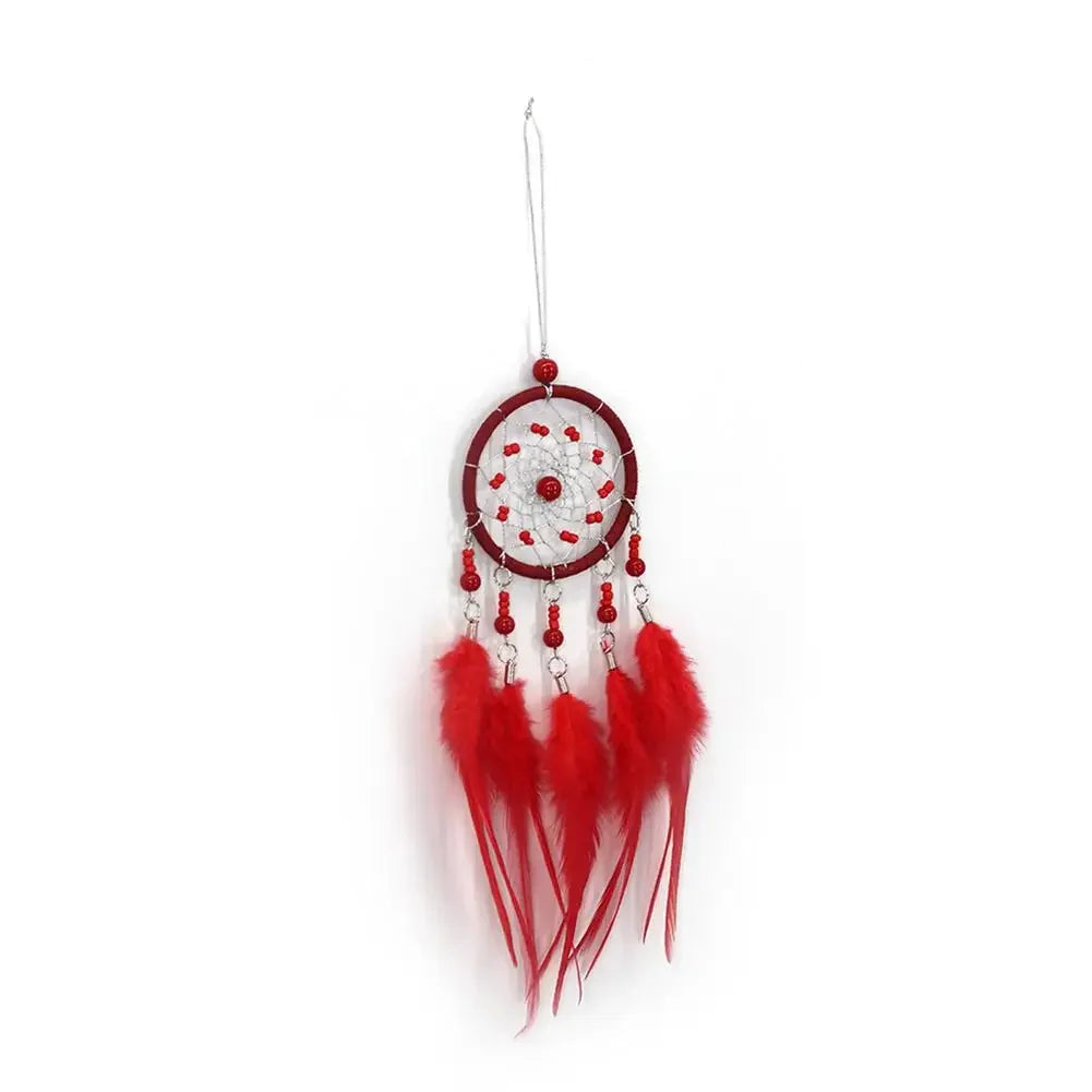 Red dreamcatcher with feathers on a white background