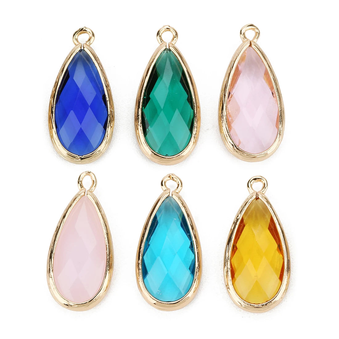 Set of six teardrop-shaped gemstones with gold settings on a white background