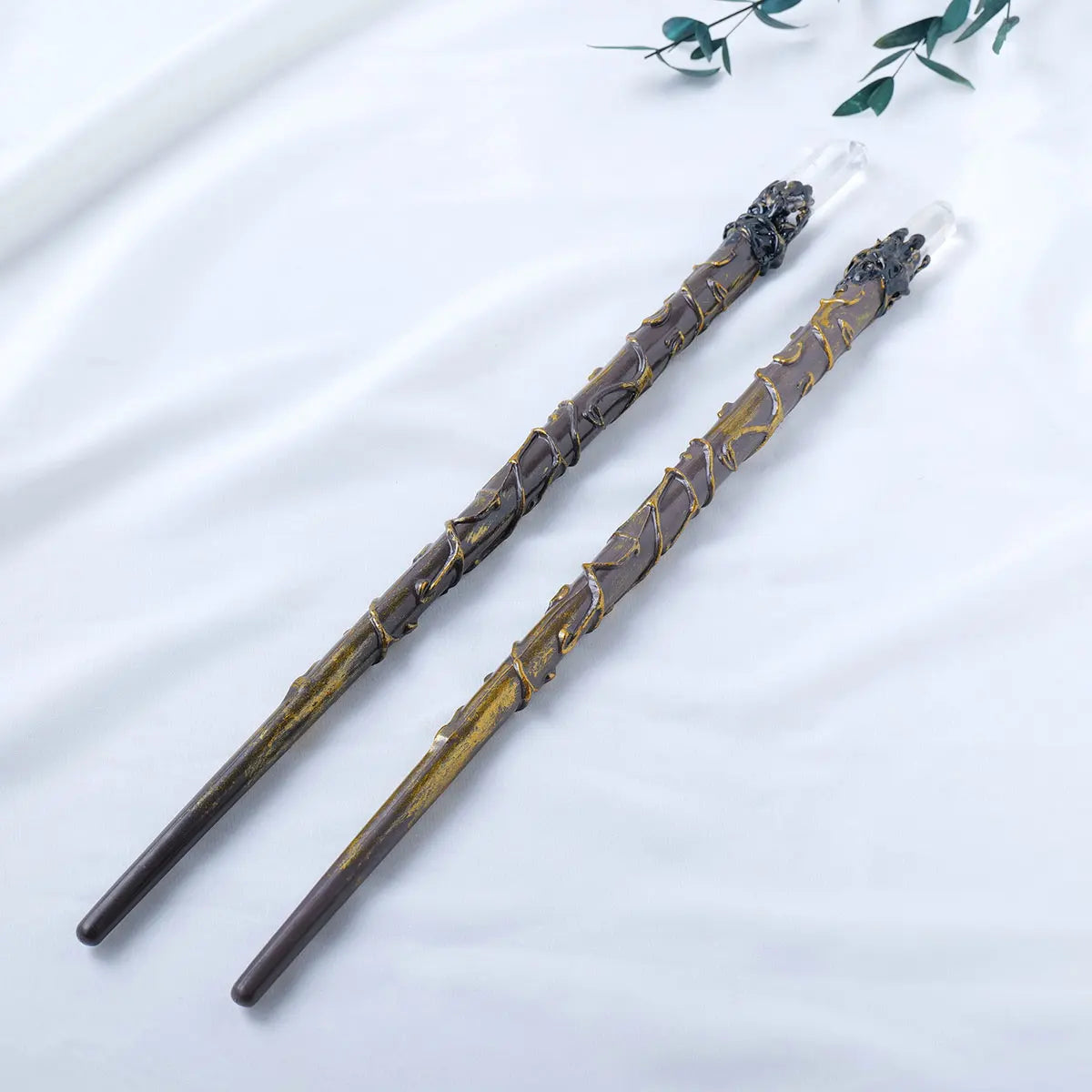 Two decorative wands with intricate designs on a light background