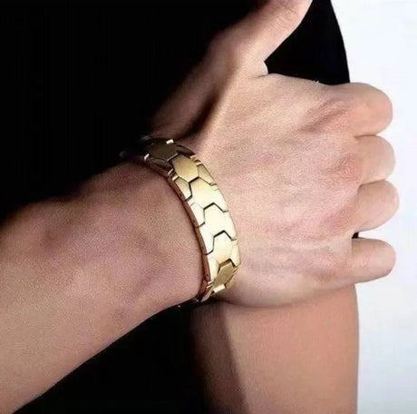 Gold bracelet on a wrist with a blurred background