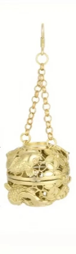 Gold decorative ball with chain on a white background