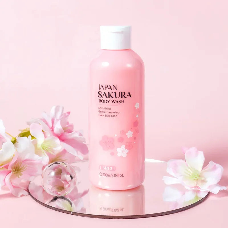 Pink bottle of Sakura body wash with cherry blossoms on a pink background