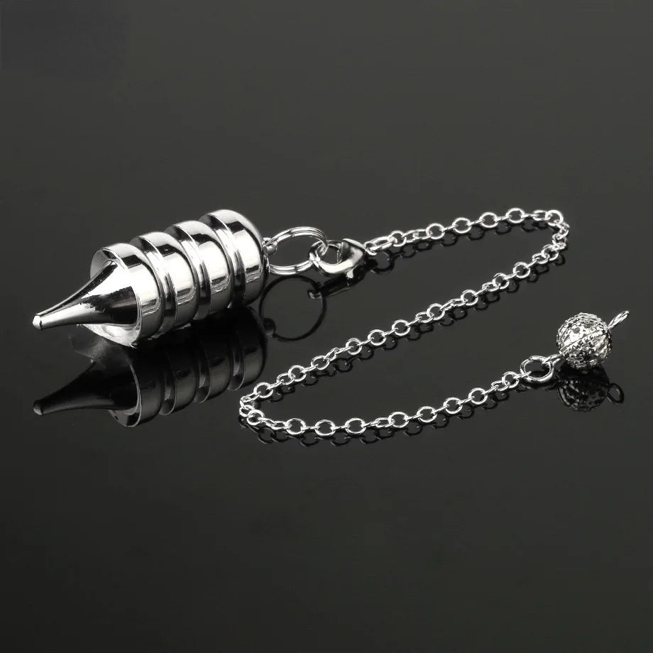 Silver metal tool with chain on a black background