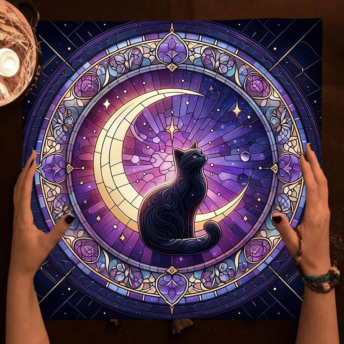 Colorful mandala with a cat silhouette held by hands on a dark background