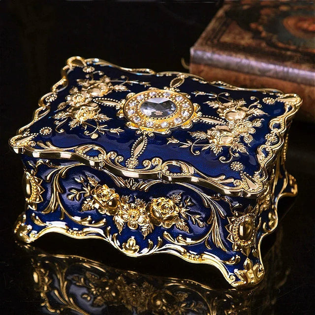 Decorative blue and gold box with intricate designs on a dark surface