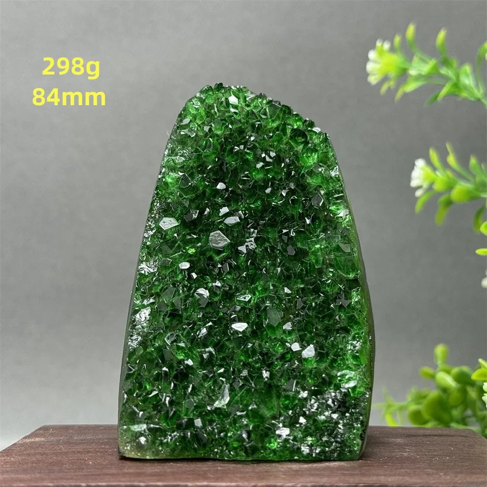 Green crystal rock on a wooden surface with a gray background