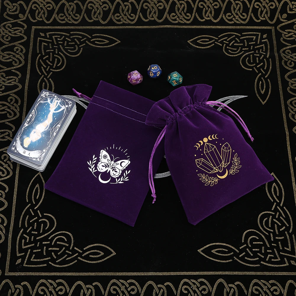 Two purple drawstring bags with embroidered designs on a black background with gold patterns.