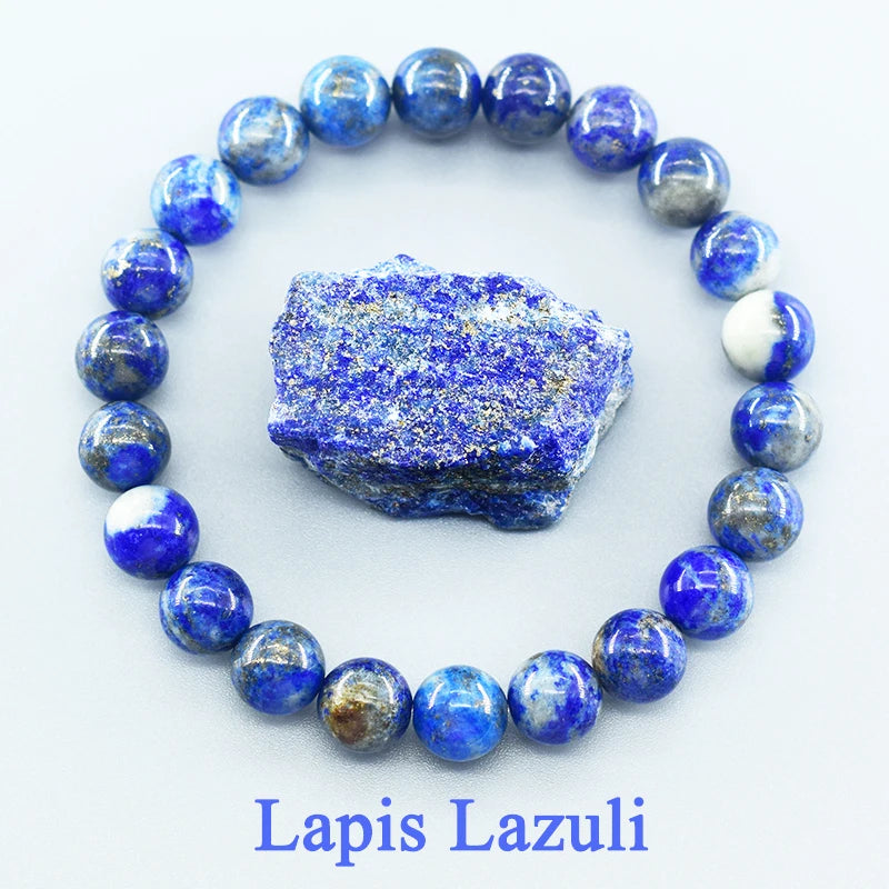 Lapis Lazuli beaded bracelet with a piece of raw lapis lazuli stone on a white background
