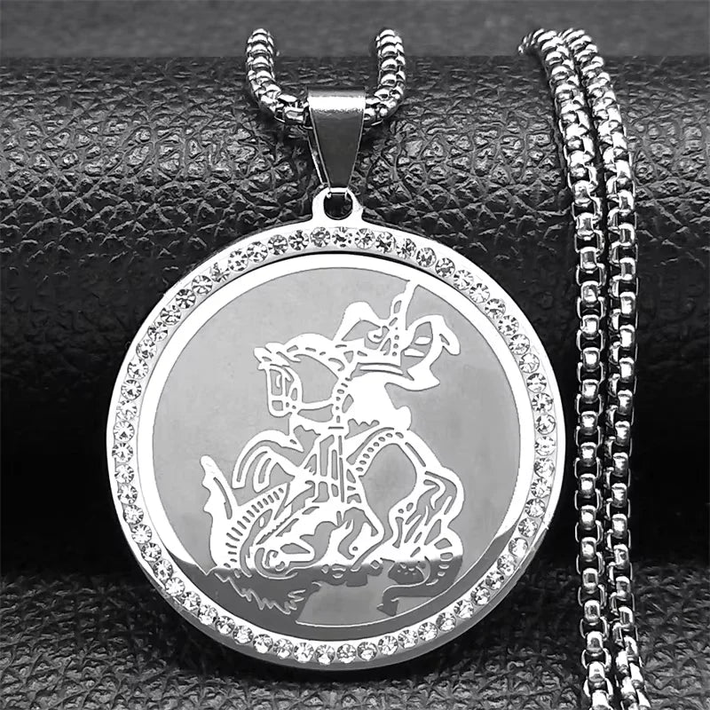 Silver pendant with intricate design on a textured surface