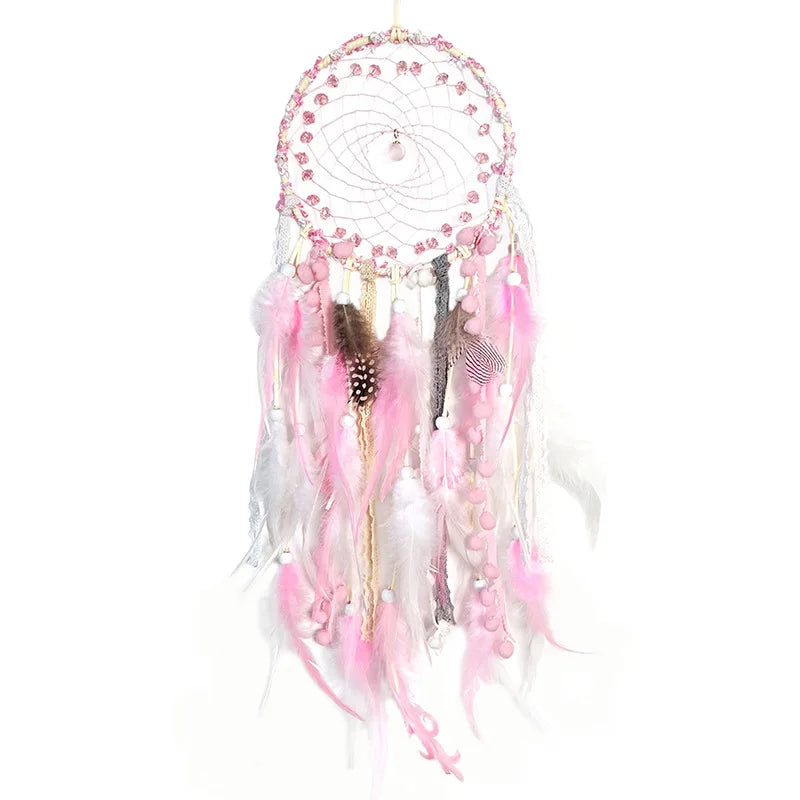 Pink and white dreamcatcher with feathers on a white background