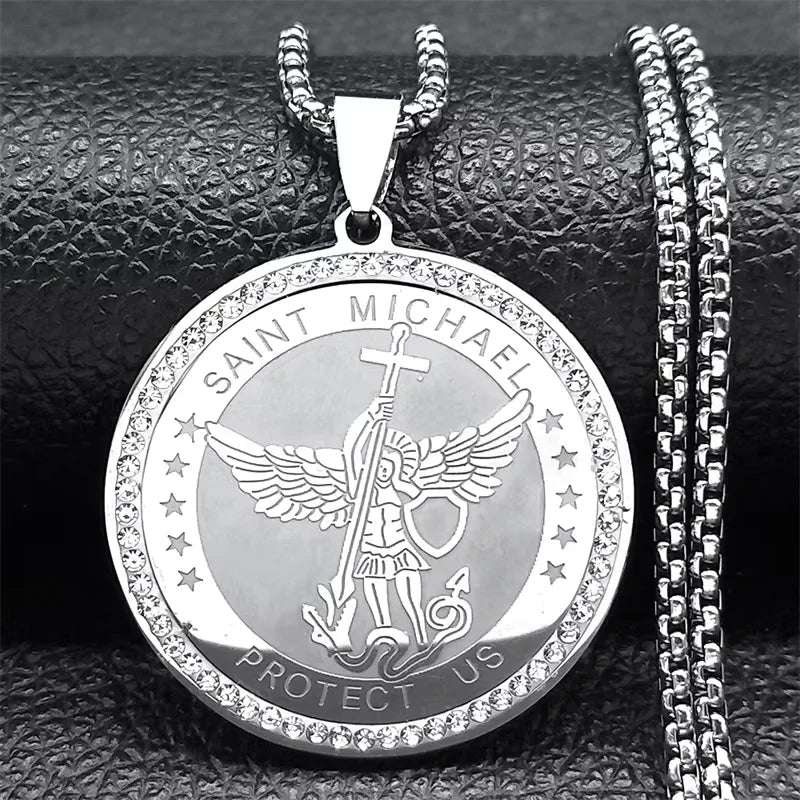 Silver Saint Michael pendant on a textured black surface