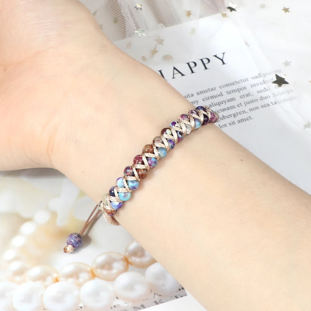 Multicolored beaded bracelet on a wrist with a soft focus background