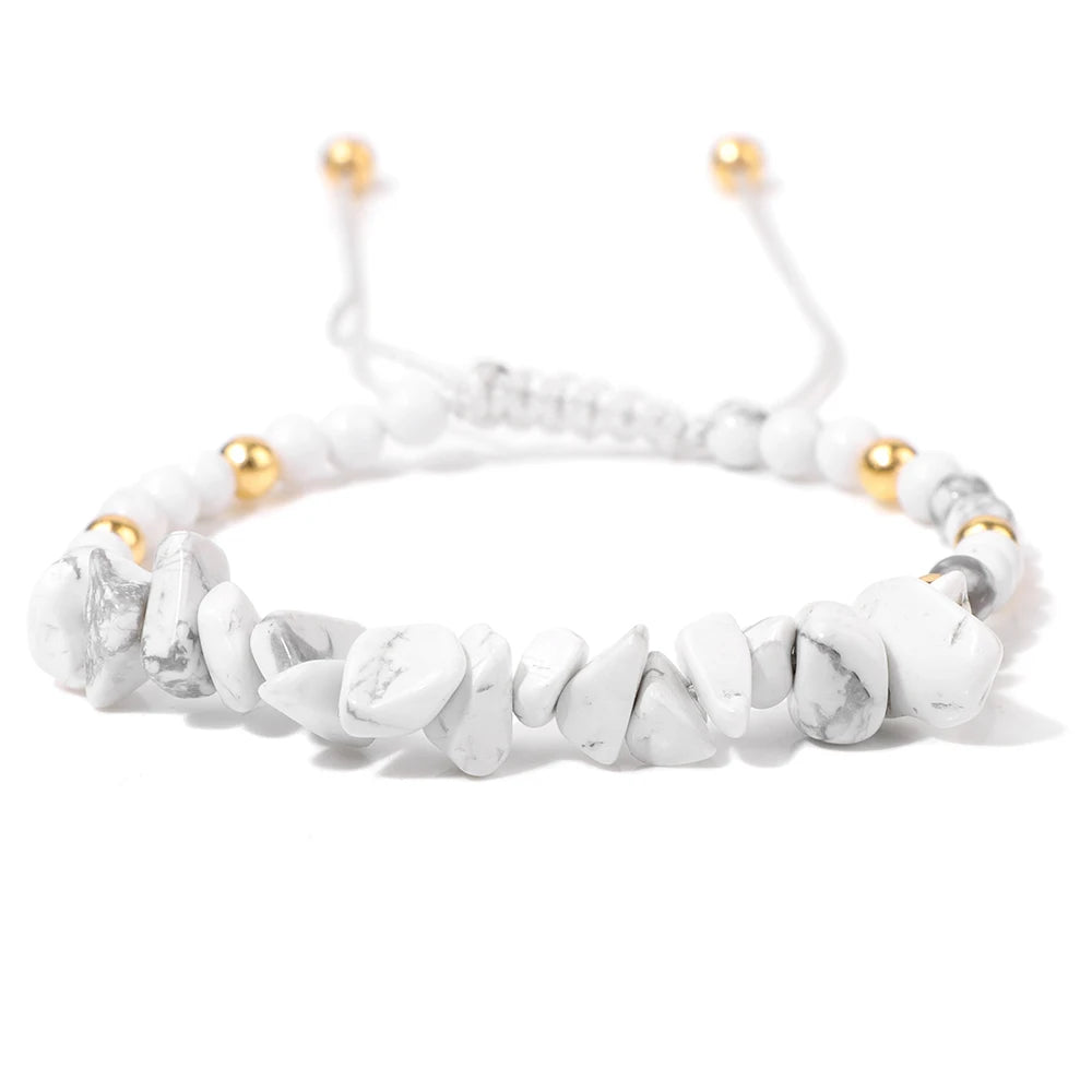 White beaded bracelet with gold accents on a white background