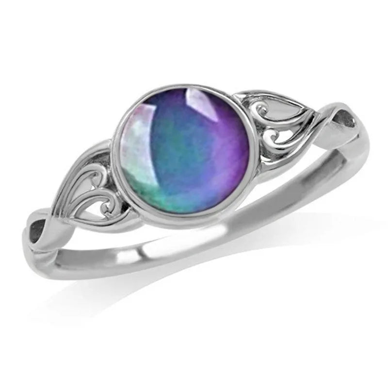 Silver ring with a purple gemstone on a white background