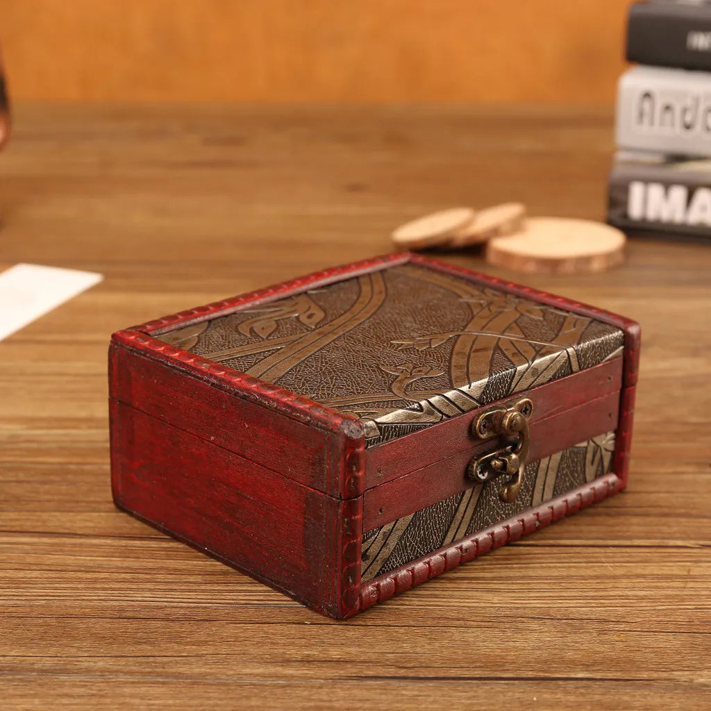 Wooden jewelry box with decorative lid on a wooden surface