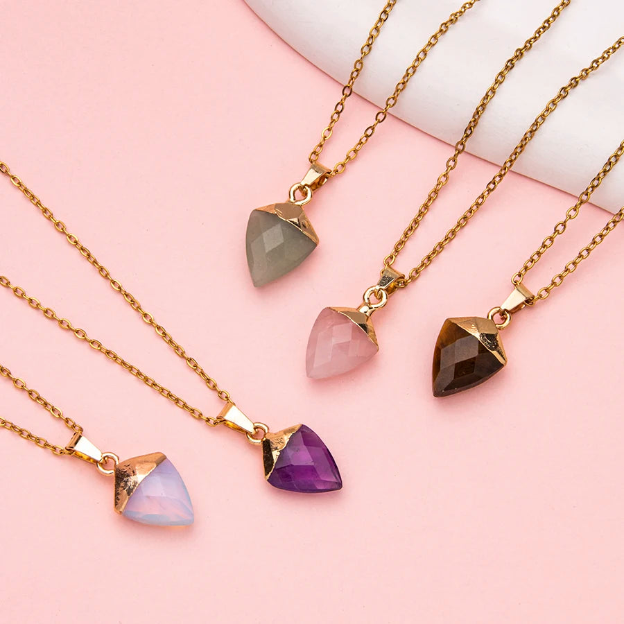 Five gold necklaces with teardrop-shaped pendants