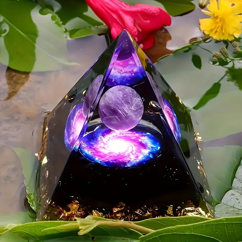 Triangular crystal with glowing purple and blue light on a reflective surface with leaves and flowers.