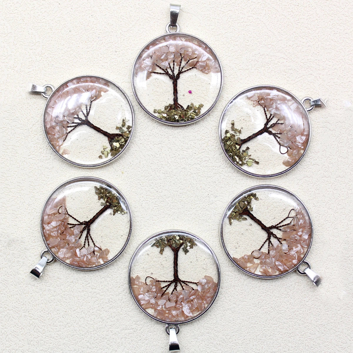 Set of six tree-themed pendants on a white background