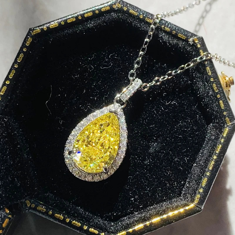 Yellow diamond pendant in a hexagonal black velvet box with gold accents