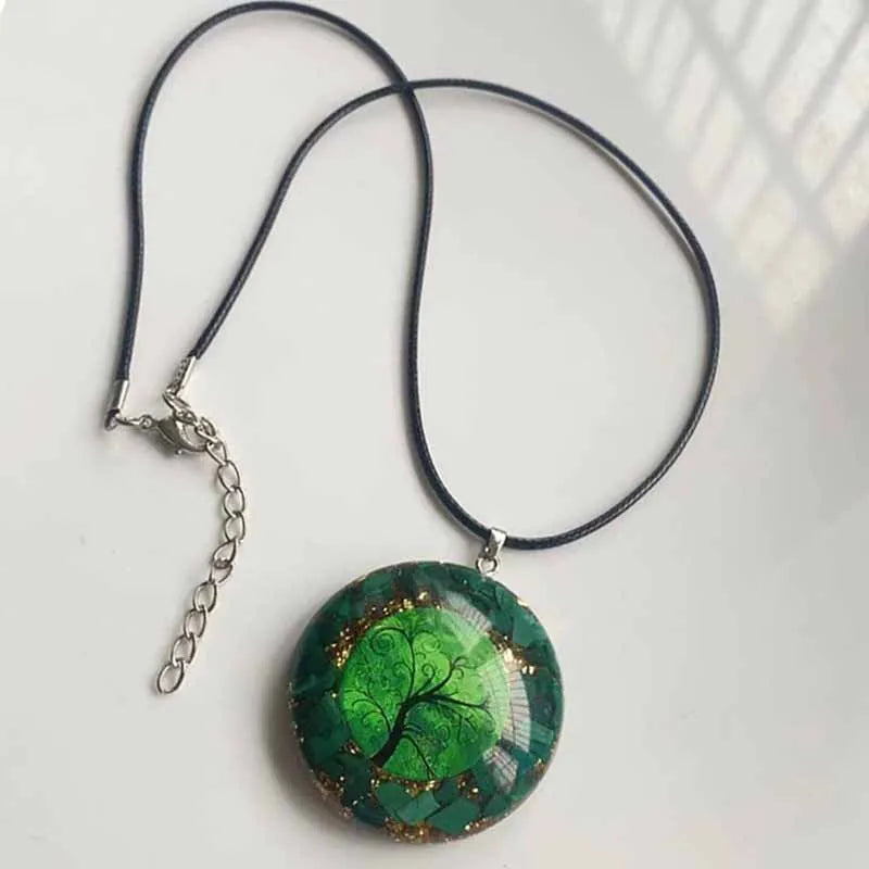 Necklace with a green pendant featuring a tree design on a white background