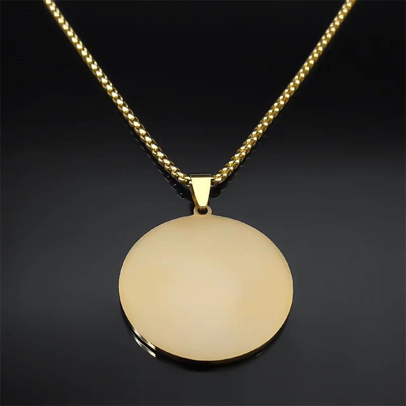 Gold necklace with a round pendant on a dark background