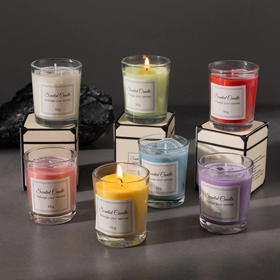 Set of scented candles in various colors with labels on a dark background