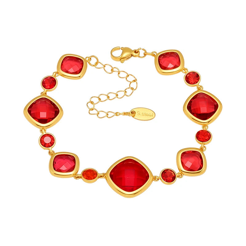 Gold bracelet with red gemstones on a white background, featuring the brand 'Liora'.