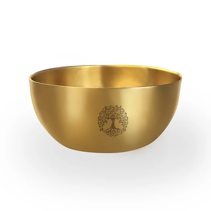 Gold bowl with a tree of life design on a white background
