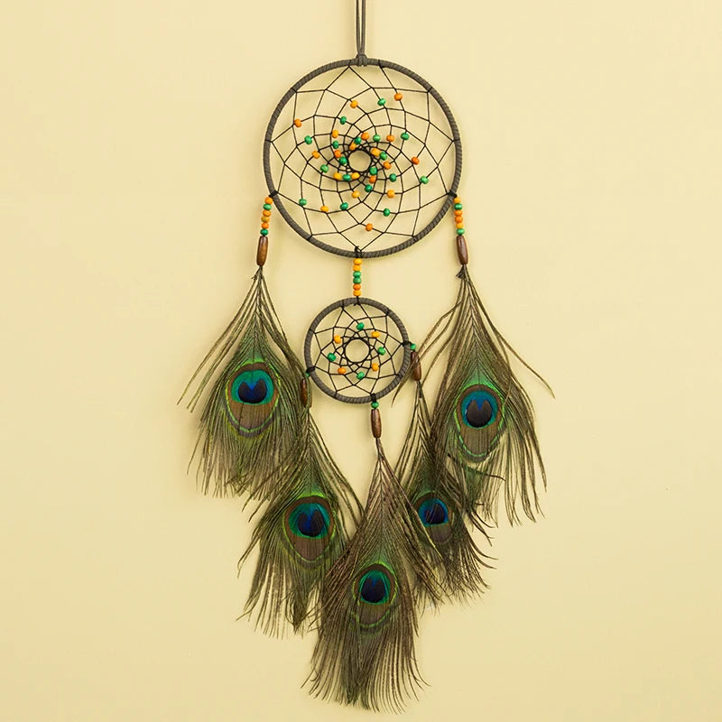 Dreamcatcher with peacock feathers on a beige background
