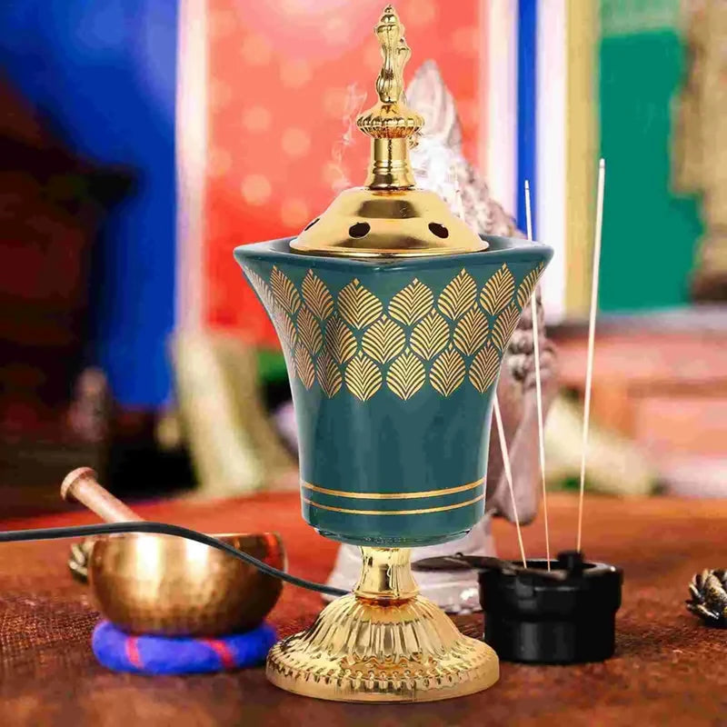 Decorative teal and gold incense burner on a wooden surface with colorful background