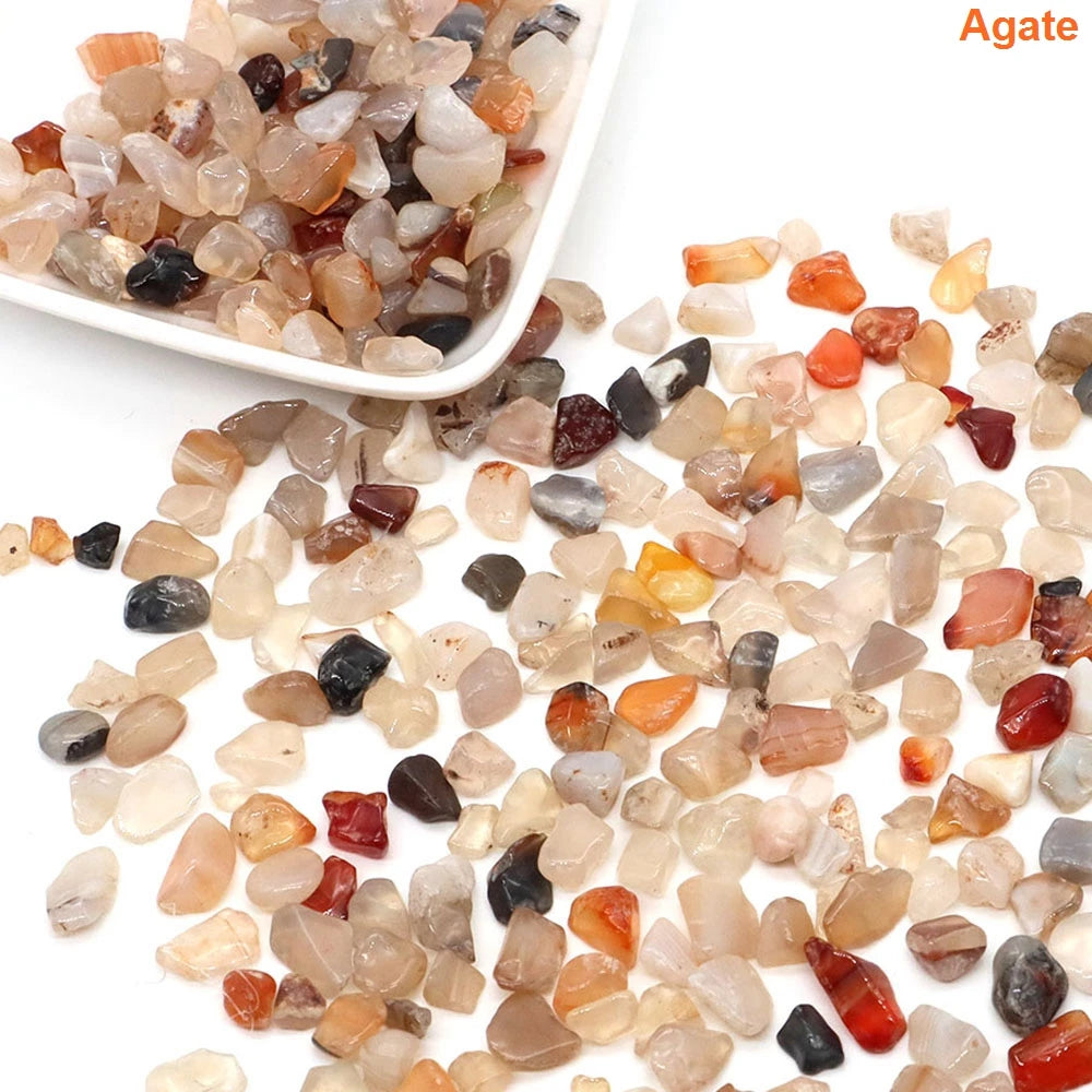 Assorted agate stones on a white background with a bowl of stones.