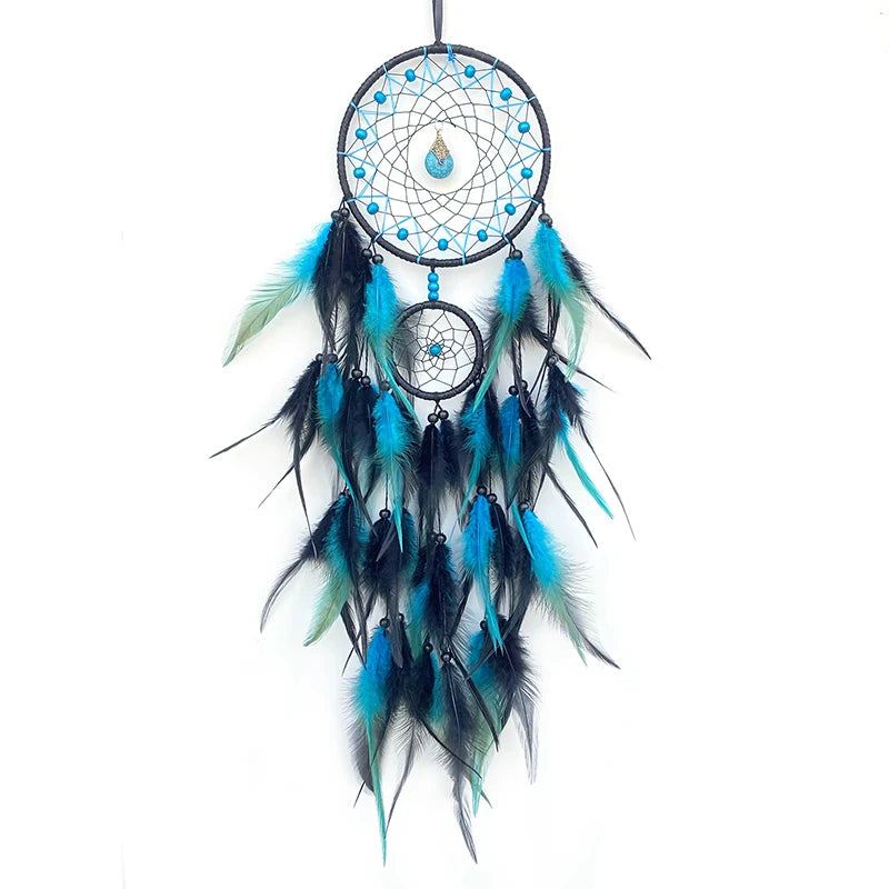 Blue and black dreamcatcher with feathers on a white background