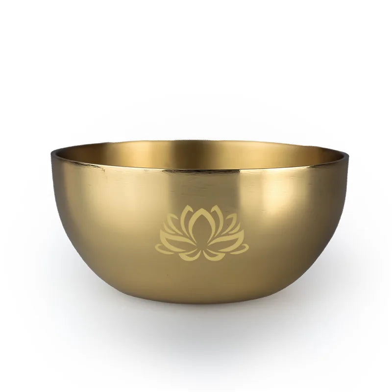 Gold bowl with a lotus flower design on a white background