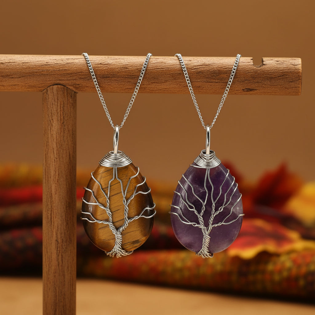 Two tree-shaped stone pendants, one brown and one purple, on silver chains against a white background.