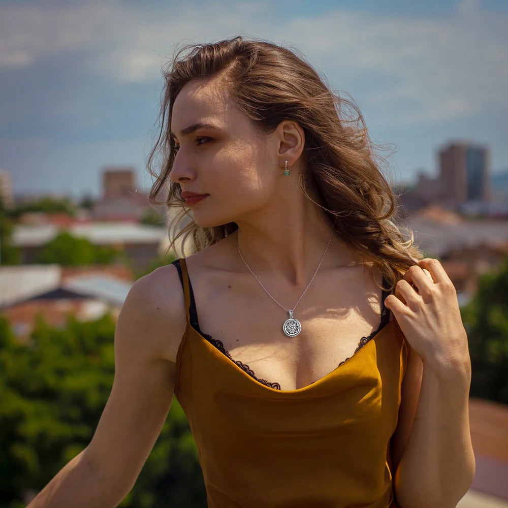 Woman in a yellow top with a cityscape in the background