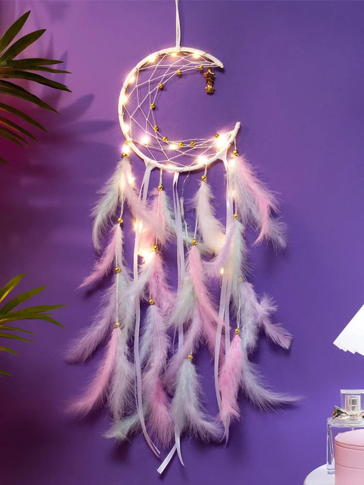 Decorative dreamcatcher with feathers and lights on a purple wall
