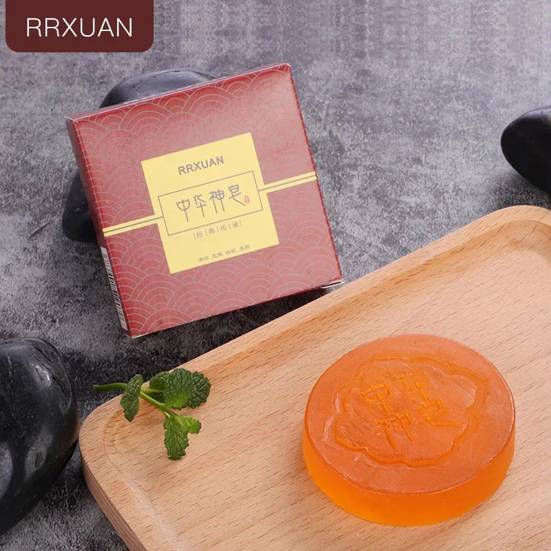 Orange soap bar with floral design on a wooden tray, next to a red RRXUAN branded box.