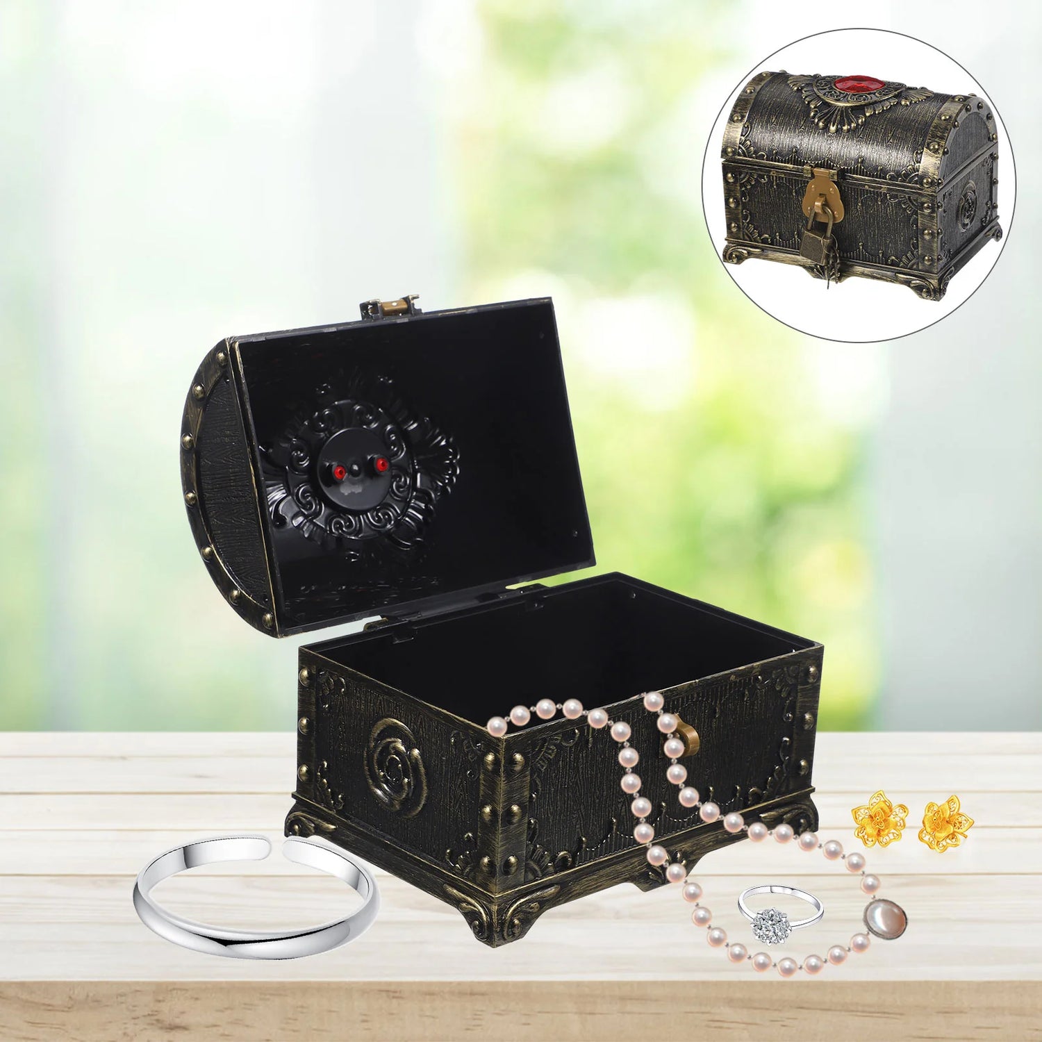 Decorative black jewelry box with jewelry on a wooden surface